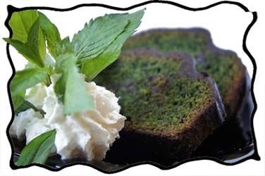 Green mint chocolate cake slices with whipped cream and fresh mint leaves