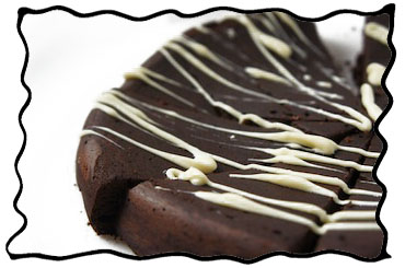 Decorating flourless chocolate cake with white chocolate