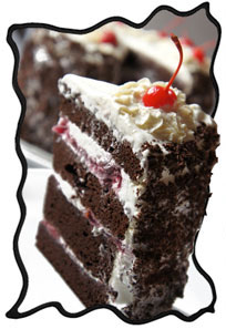 Tall slice of black forest cake with Maraschino cherry